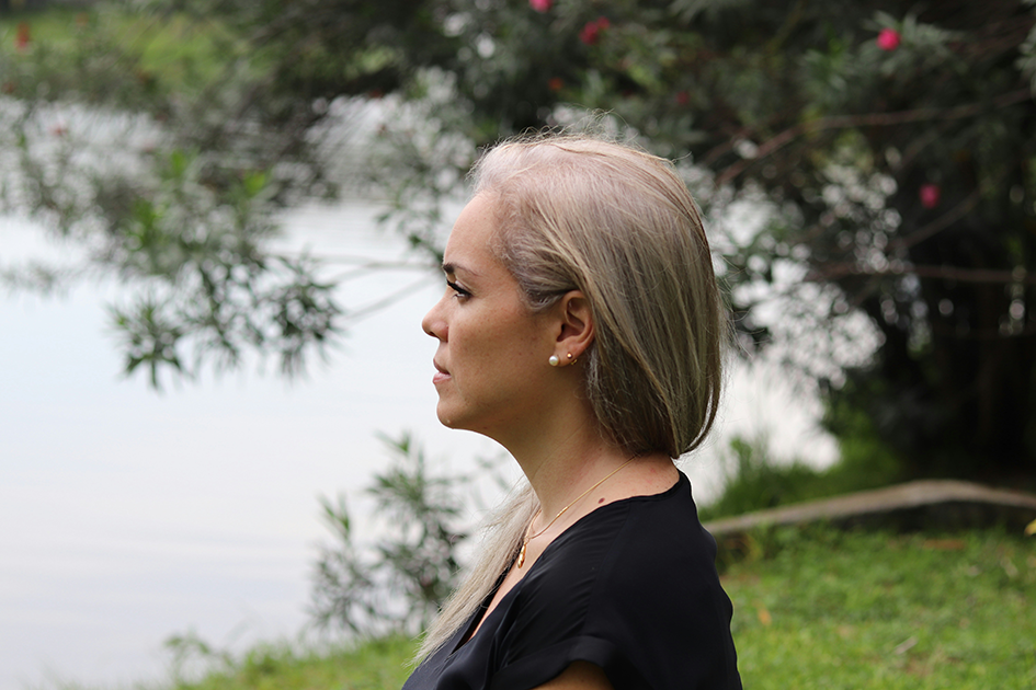 Woman outdoors looking calm and reflective, representing stress and emotional wellness