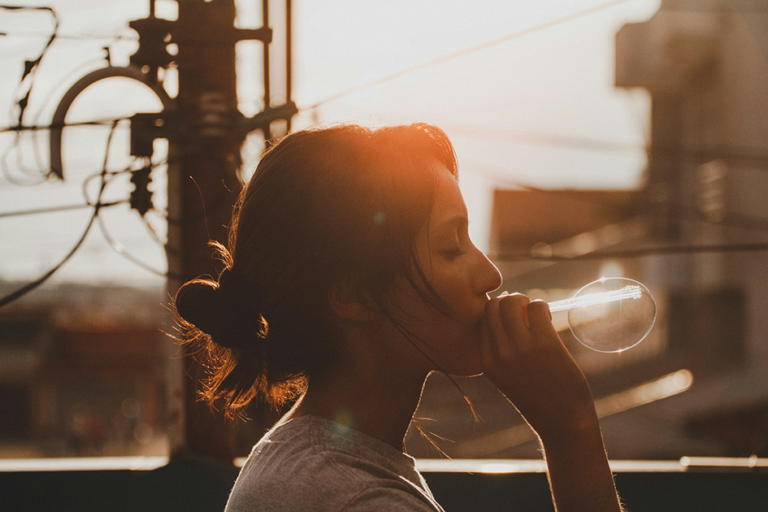 Woman drinking warm water in the morning for digestion