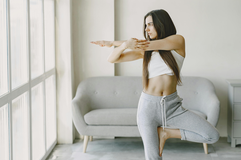 Woman doing a toning workout at home in natural light