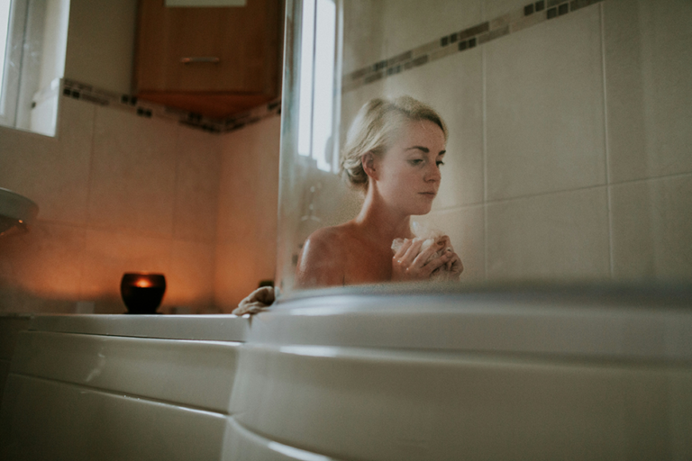 Woman applying simple skincare routine in natural light