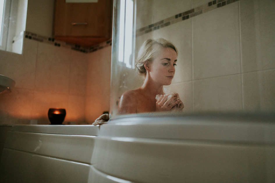 Woman applying simple skincare routine in natural light