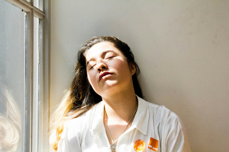 Woman feeling calm and relaxed in soft morning light