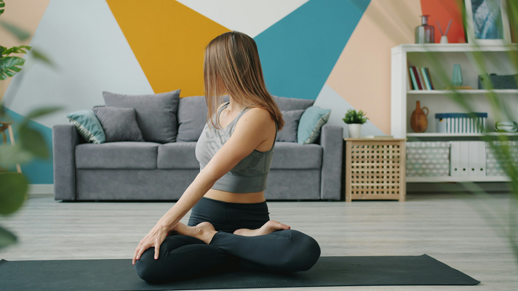 Pregnant woman doing gentle yoga at home