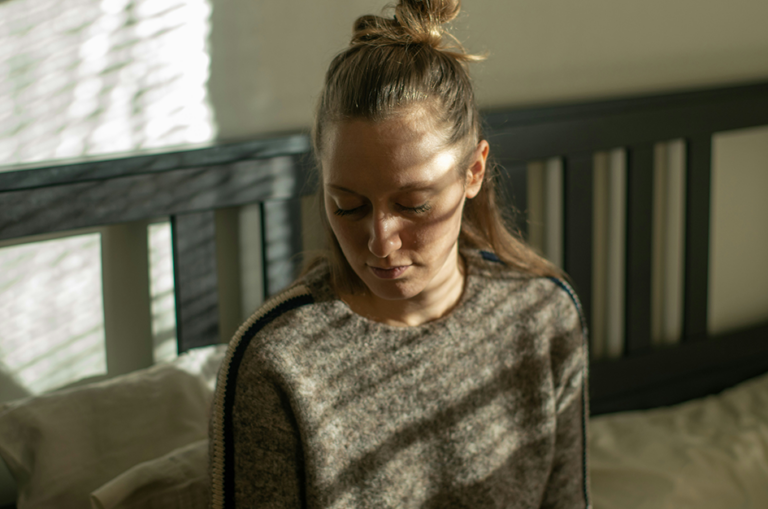 Woman experiencing fatigue and stress related to hormonal imbalance