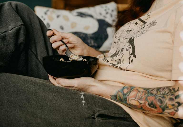 Pregnant woman eating a healthy snack while relaxing at home