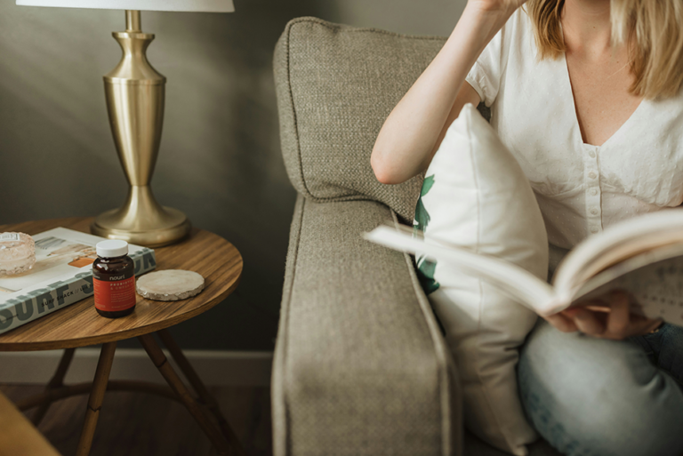Woman using a probiotic supplement to support gut health and digestion