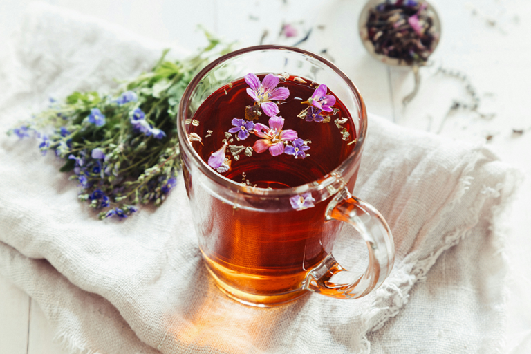 Warm herbal tea setup with calming wellness aesthetic and natural light