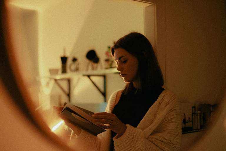 Woman reading a book in warm evening light