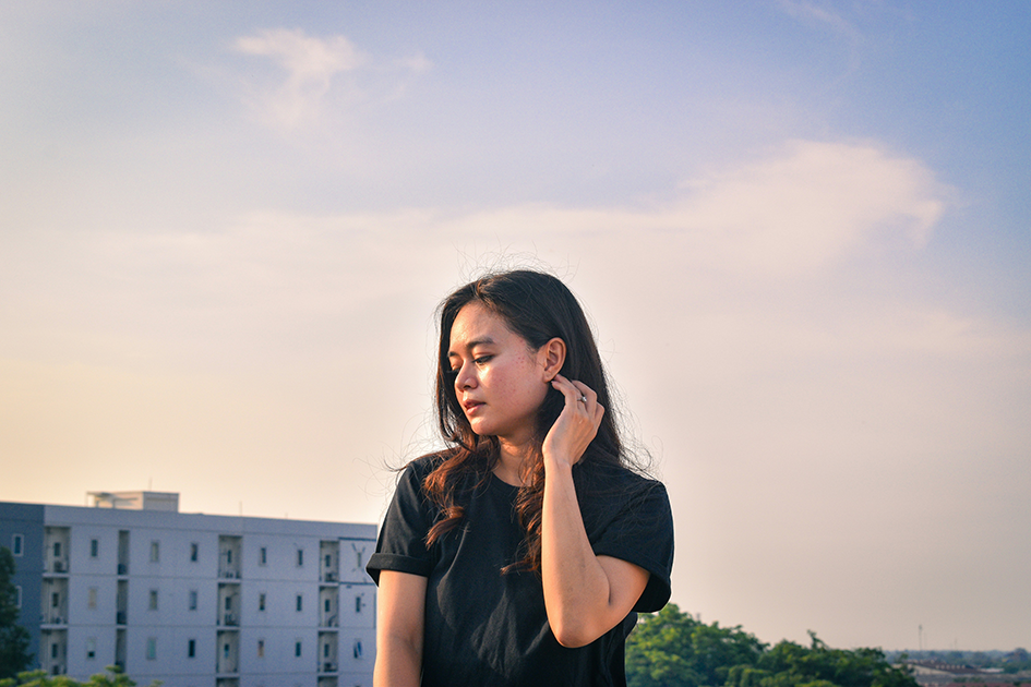 Woman with dehydrated skin touching her face outdoors in natural sunlight