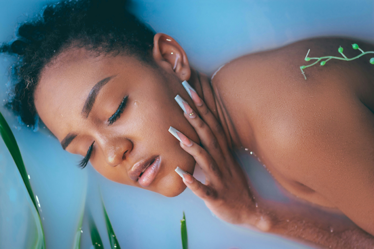 Woman with sensitive skin gently applying skincare product in soft natural light