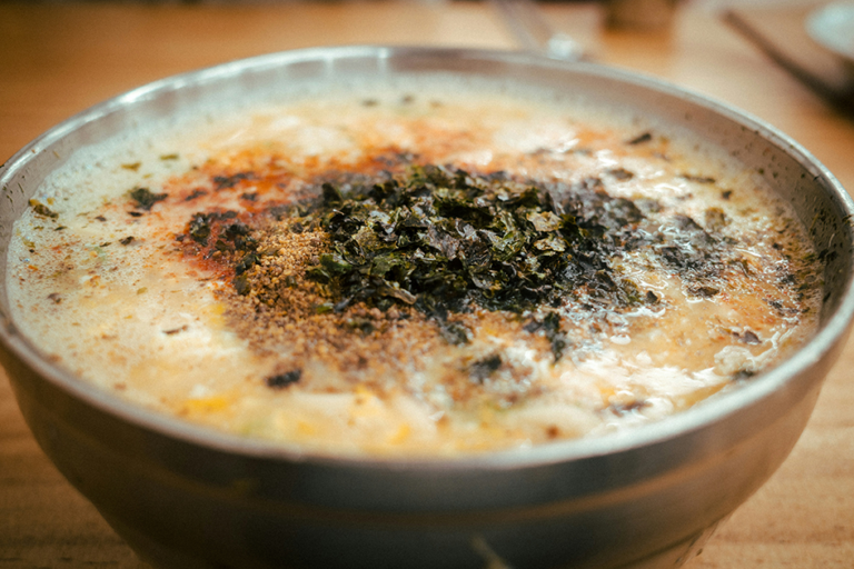 Warm bowl of cornmeal porridge with healthy toppings on a cozy breakfast table