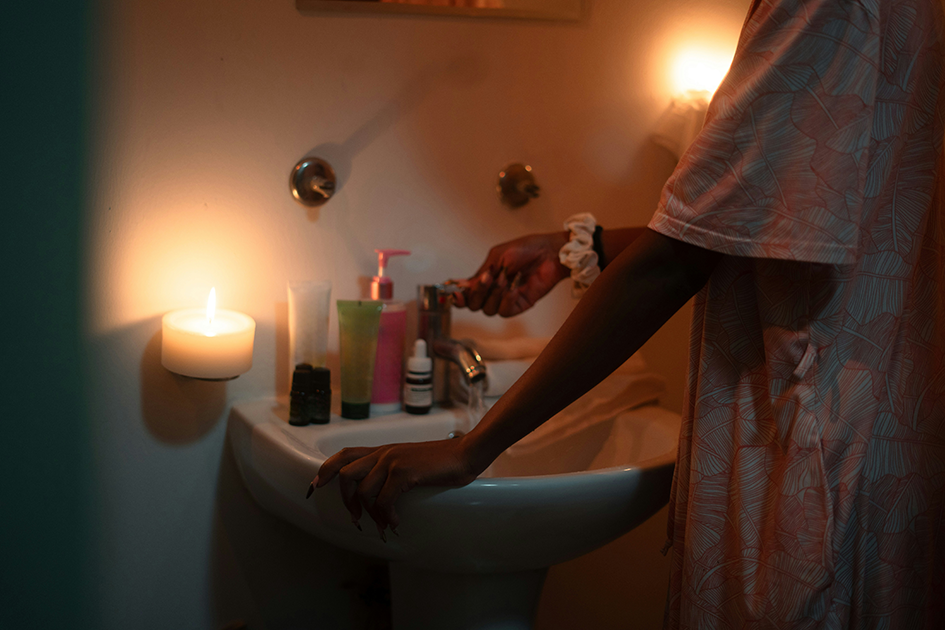 Woman applying moisturizer during her evening skincare routine