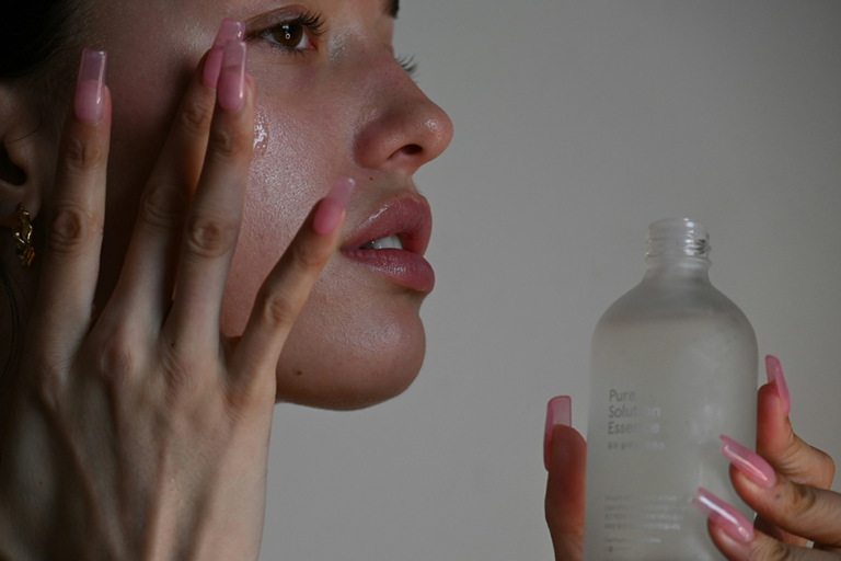 Woman applying skincare products during her morning skincare routine