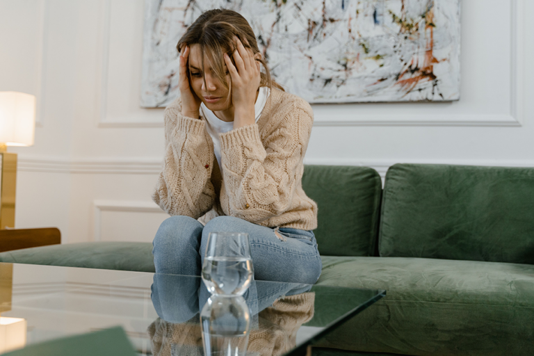 Woman experiencing emotional exhaustion while reflecting on mental well-being and self-care