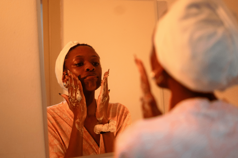 Woman washing her face before moisturizing to help prevent dry, tight skin