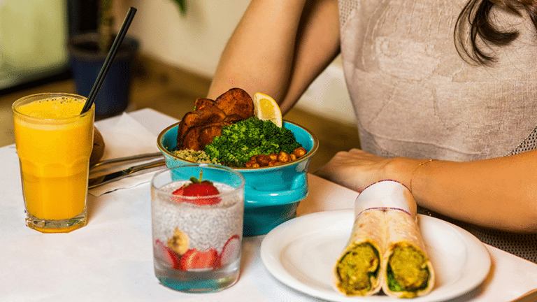 Healthy meal with smoothie, chia pudding, wrap, and vegetable bowl