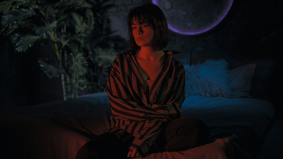 Woman sitting awake in bed at night
