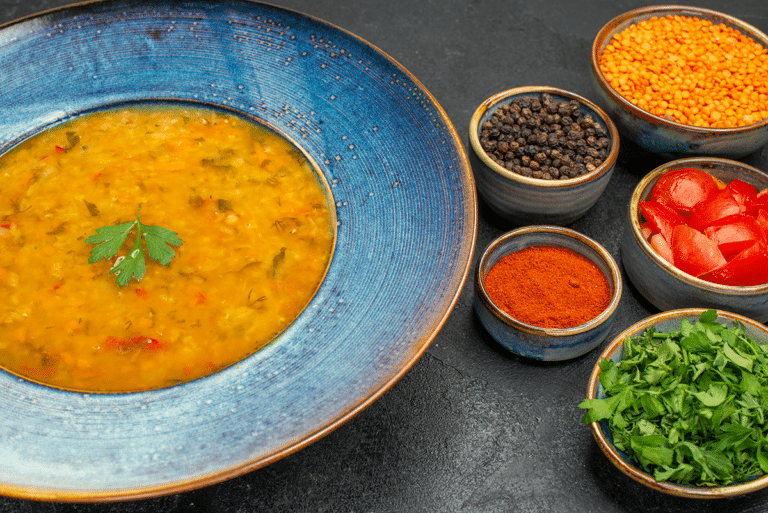 Red lentil soup with carrots, tomatoes, lemon, and fresh parsley