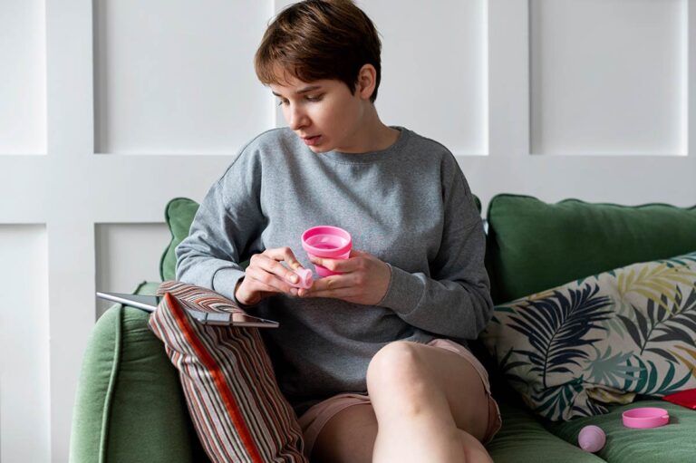 Woman with menstrual cup tracking her period at home