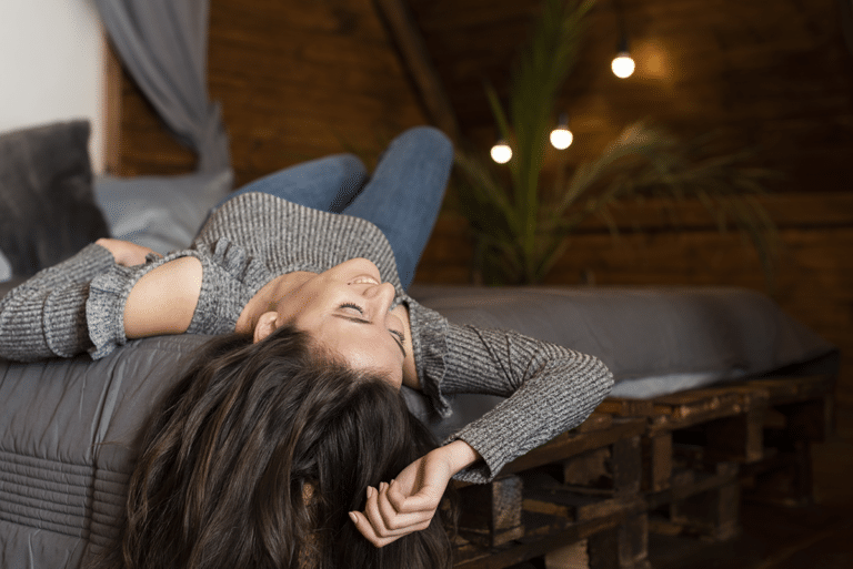 Woman relaxing in a softly lit room after an overwhelming and overstimulating day
