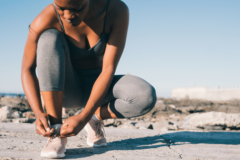 Woman tying her workout shoes