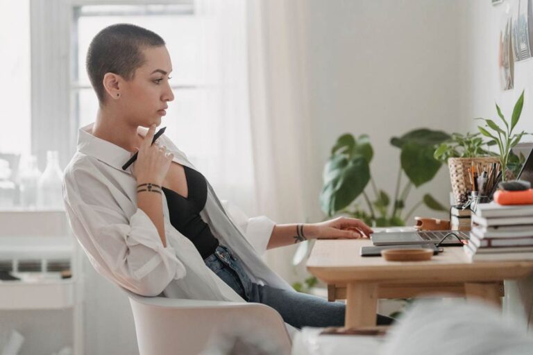 Thoughtful woman reviewing her work after noticing a small mistake, illustrating perfectionism and fear of getting things wrong