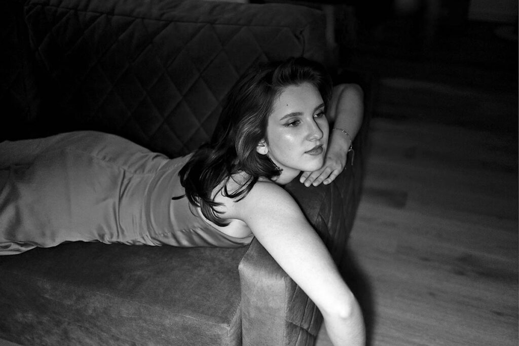 Thoughtful woman sitting on a sofa at home, illustrating anxiety and emotional changes during perimenopause