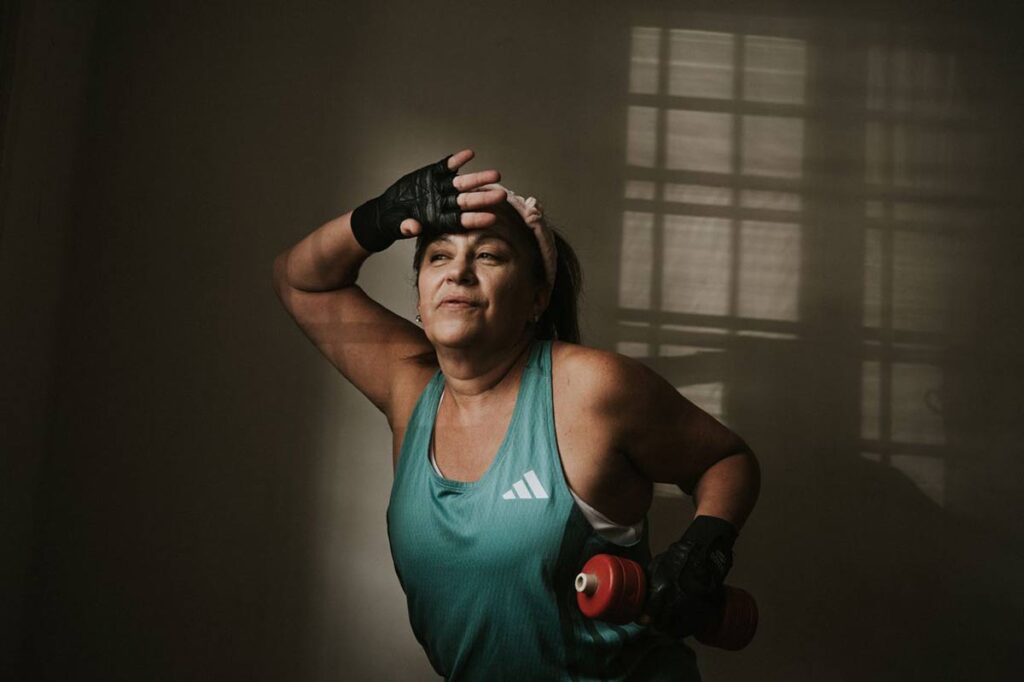 Woman doing a dumbbell workout at home and building strength safely