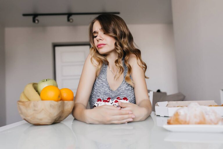 Woman experiencing digestive discomfort after eating