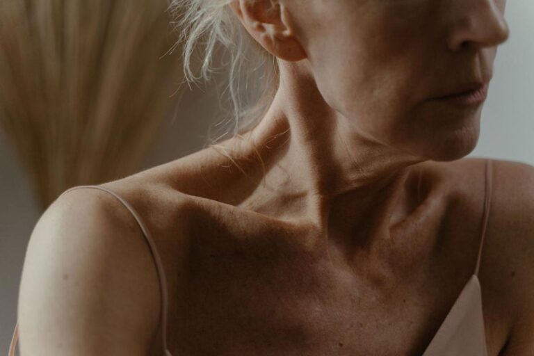 Mature woman showing natural skin texture on her face and neck