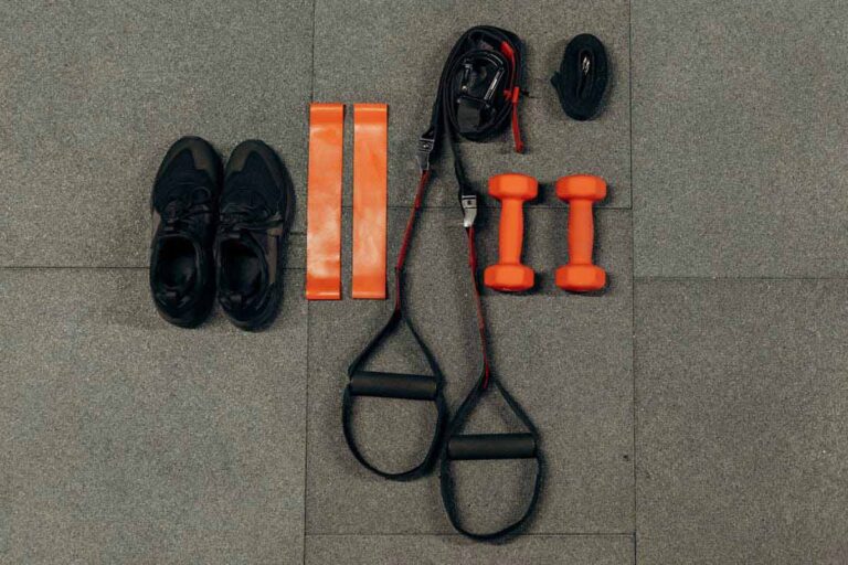 Dumbbells and resistance bands arranged for a home strength workout
